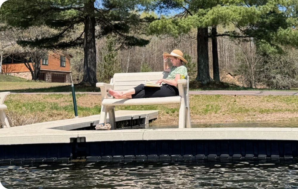 A person sitting on a bench near the water.