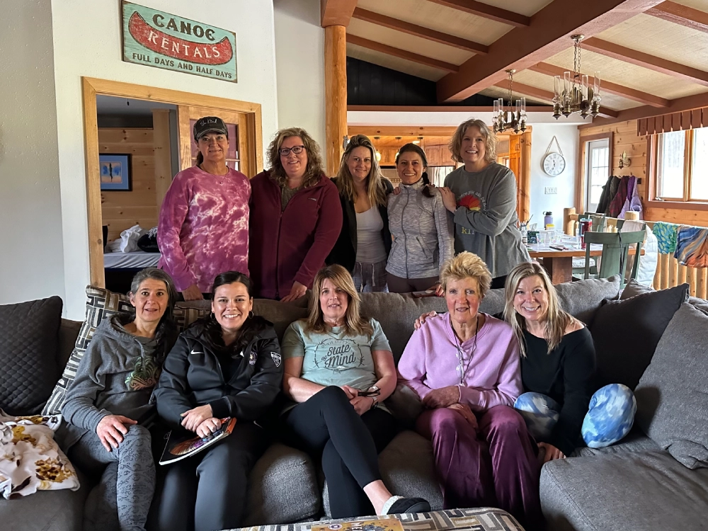 A group of women sitting on top of a couch.