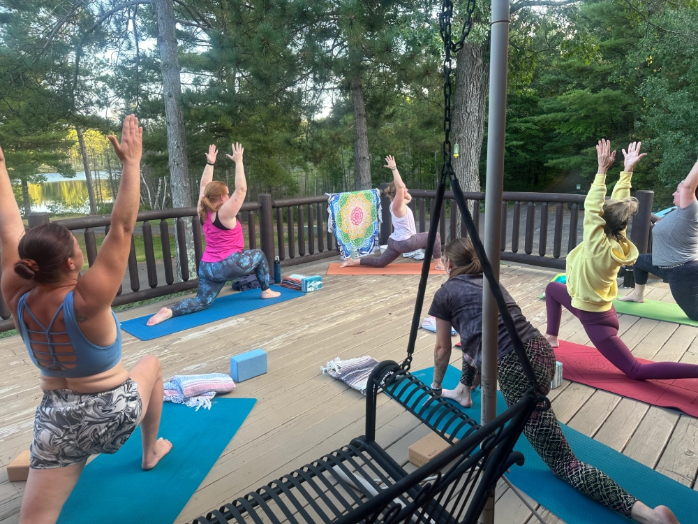 A group of people doing yoga on the deck