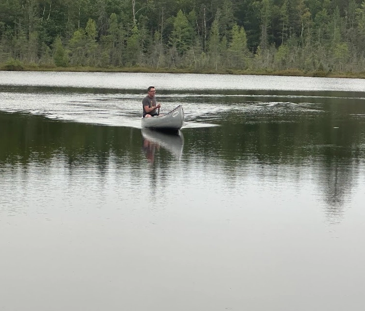 A man in a boat on the water.