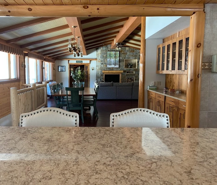 A view of a kitchen and dining room from the counter.