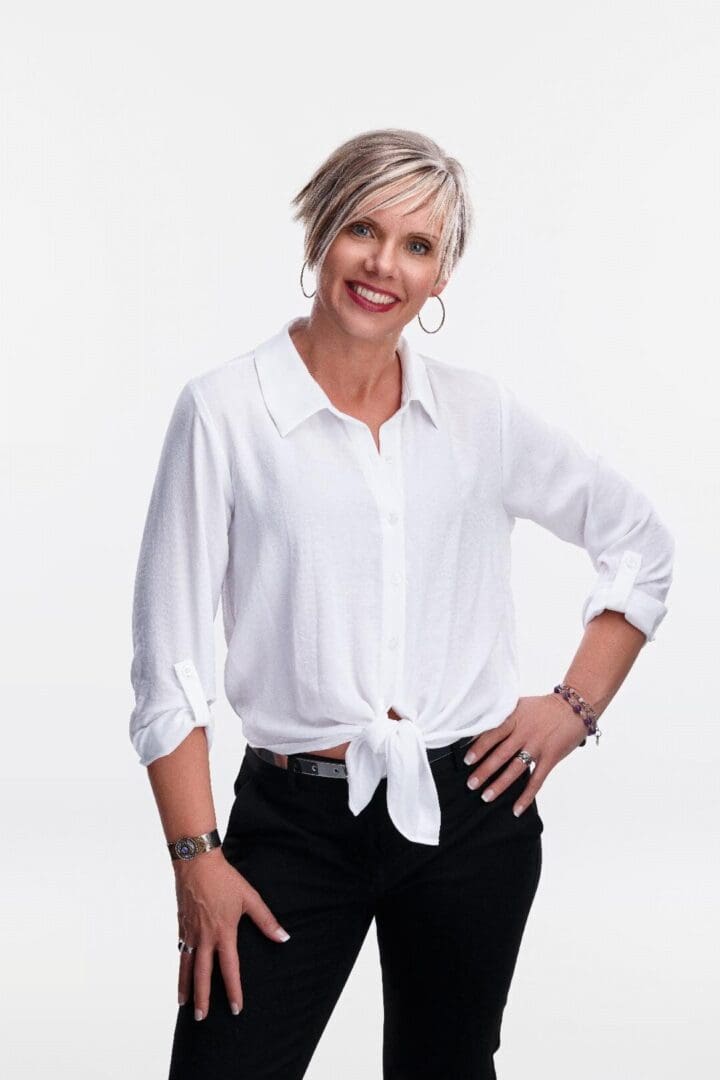 A woman standing in front of a white wall.