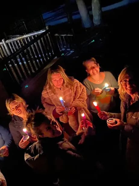 Group of friends celebrating with candles.